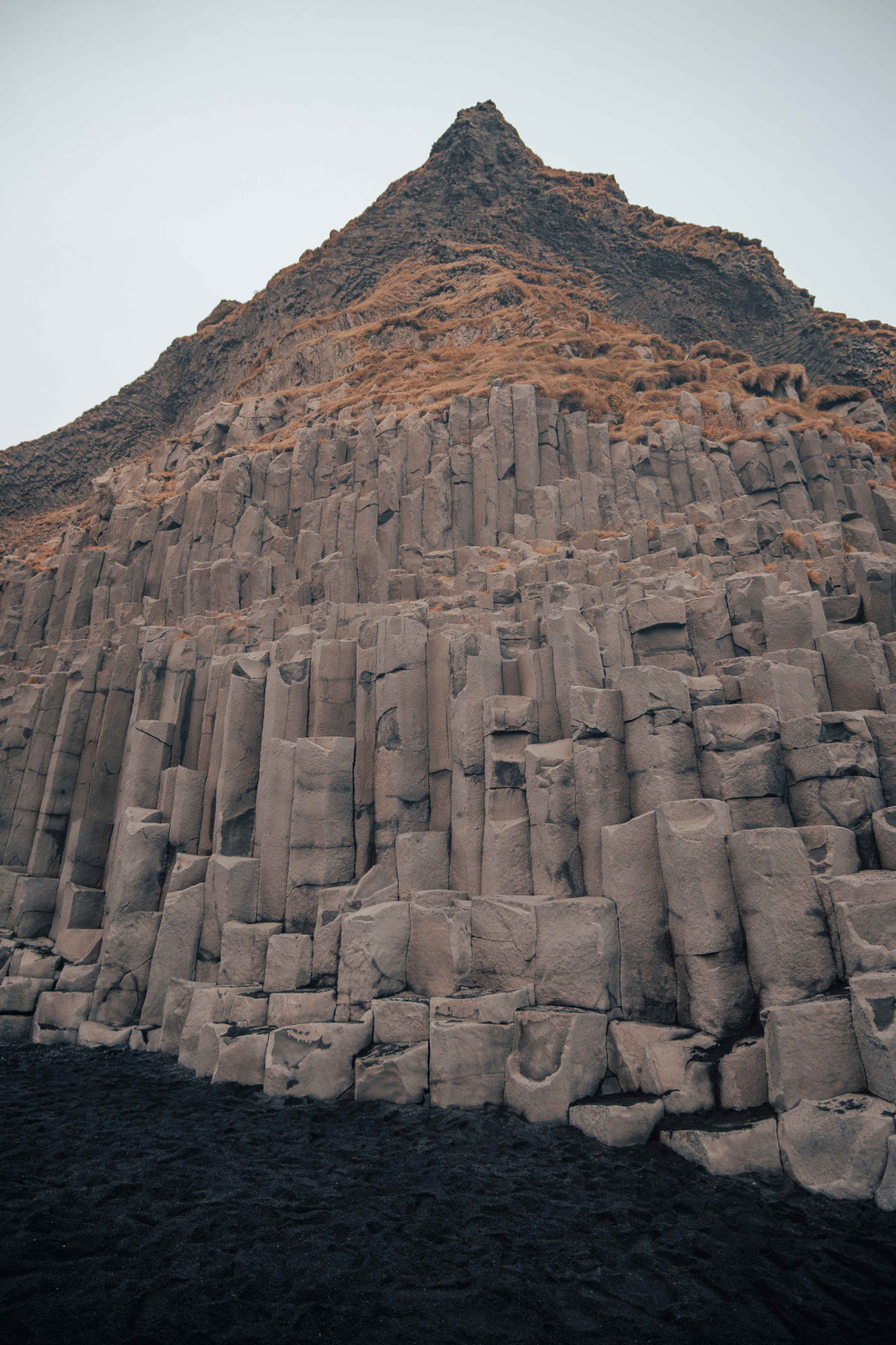 Reynisfjara beach reveals enchanting basalt formations, formed by nature's artistic touch, amidst the roaring waves.