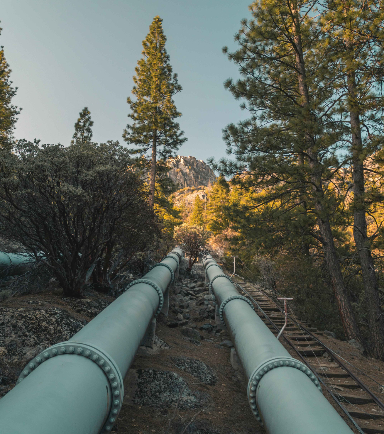 Water pipeline entering mountains from pump station, Big Creek, CA