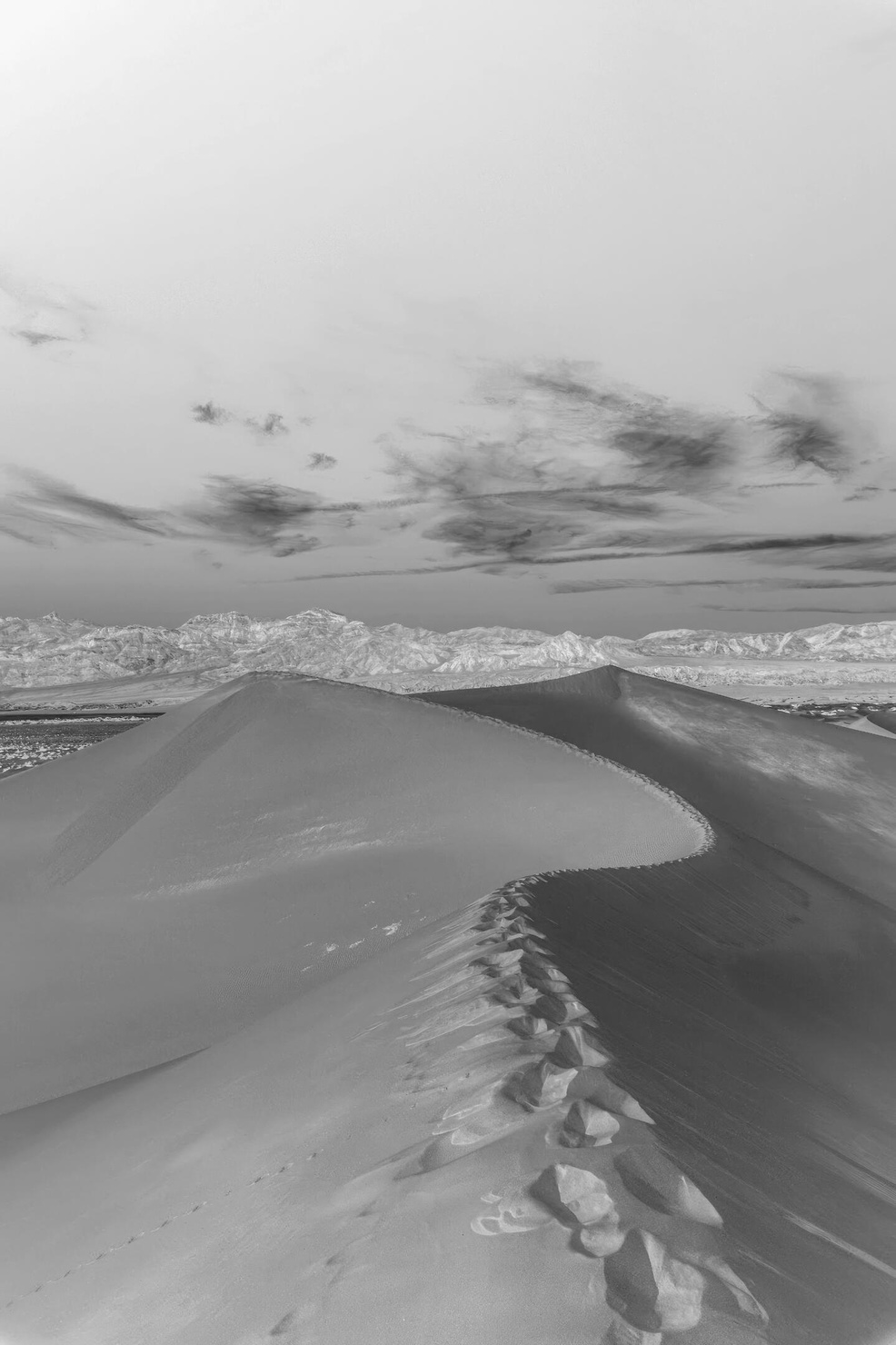 Inverted black and white image of the Mesquite Sand Dunes in Death Valley, highlighting the intricate patterns and contours of the sandy landscape